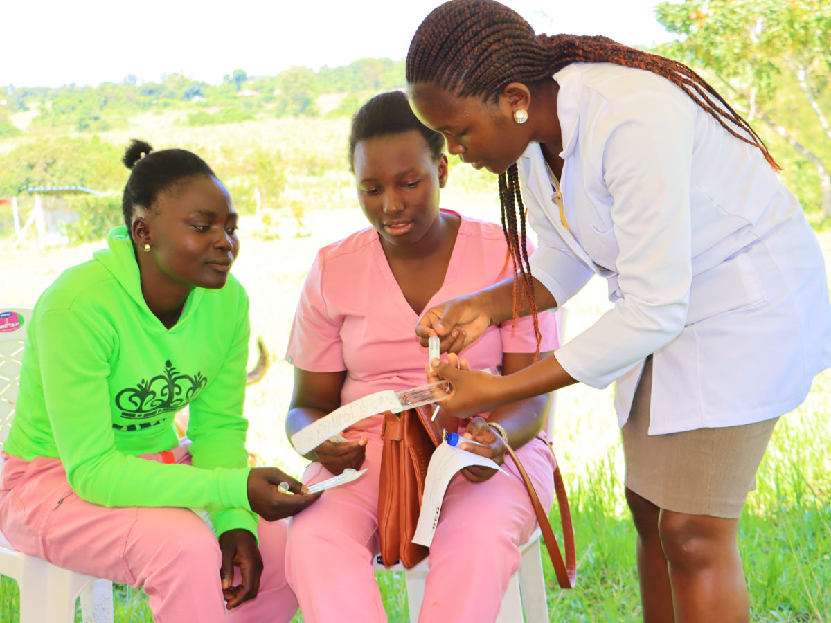 Two women receive a briefing on cervical cancer prevention from a Doctor.